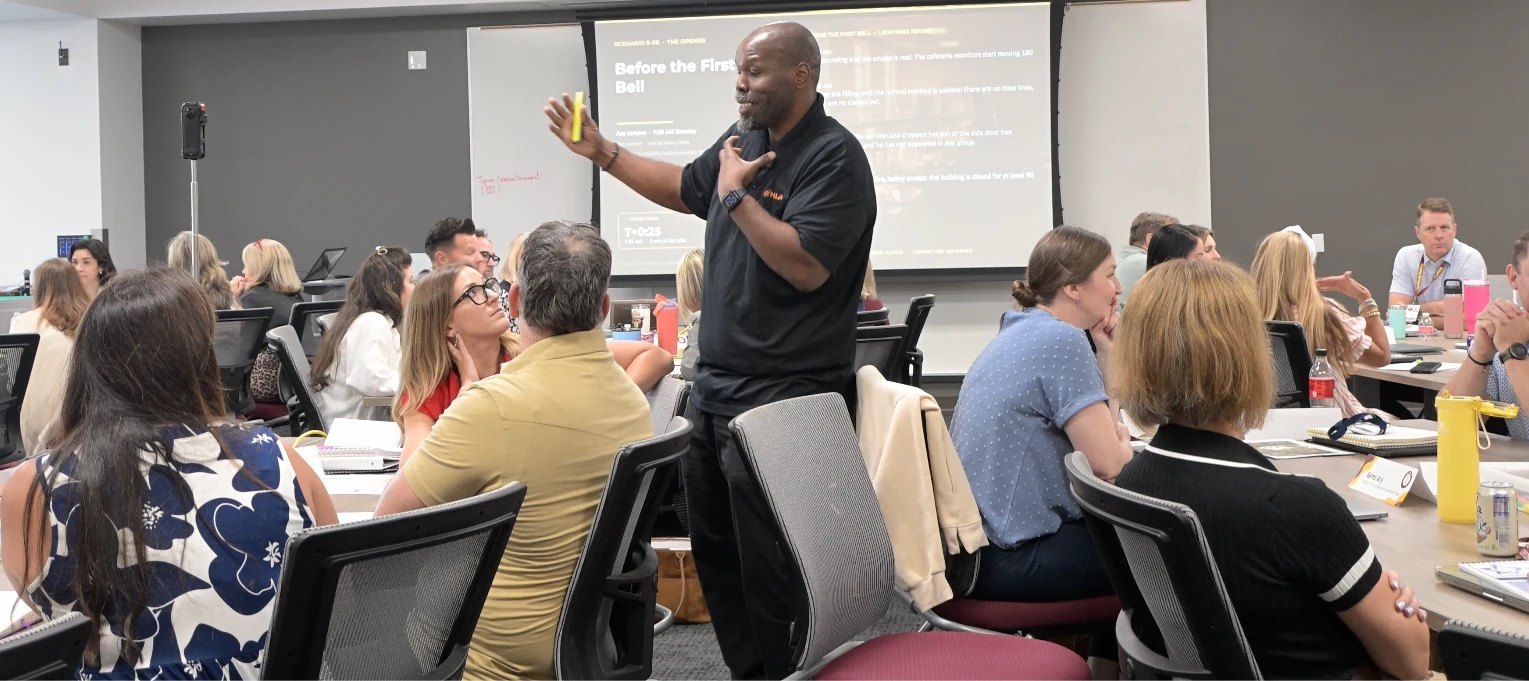 Michael Peck facilitating a school leadership tabletop discussion