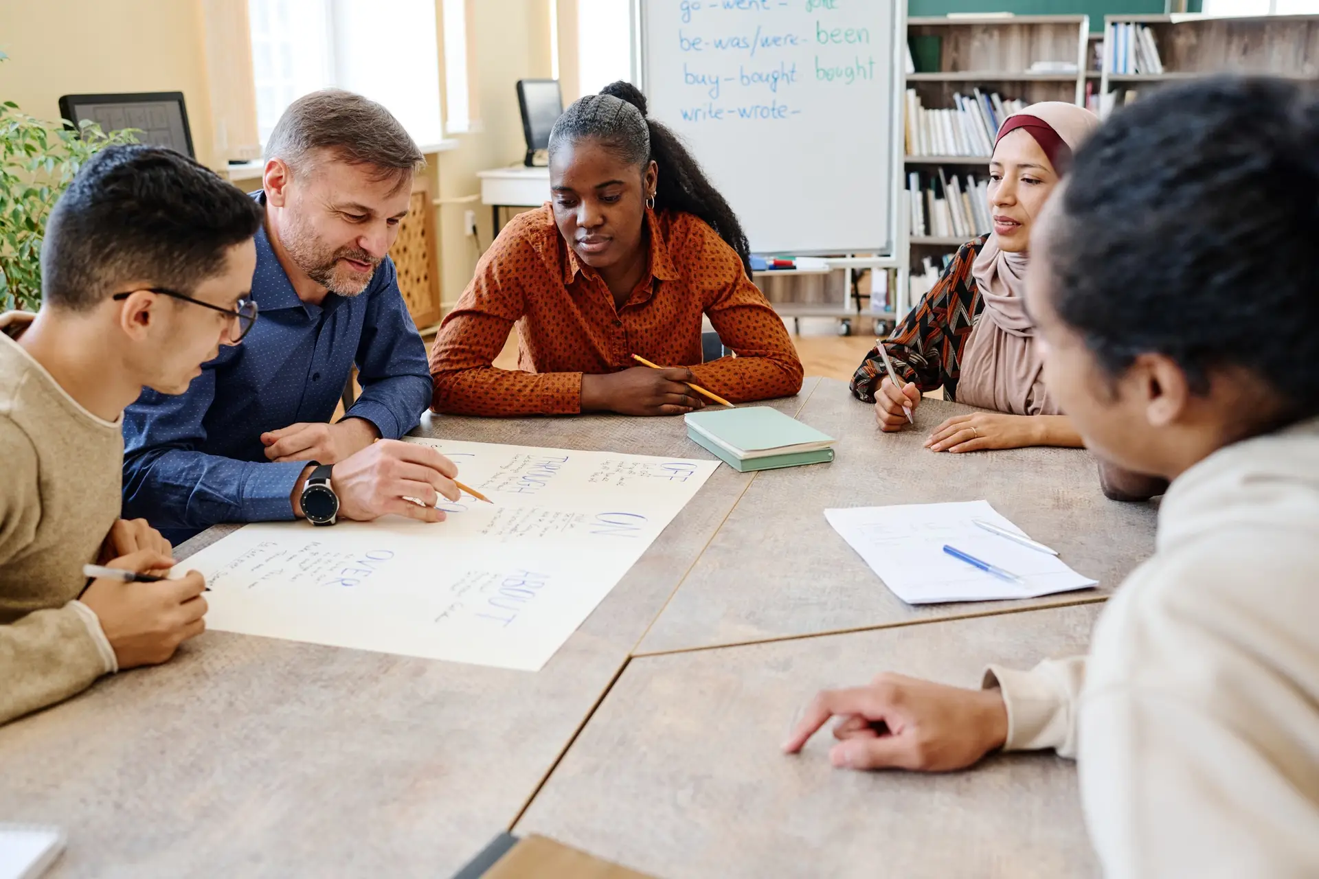Teacher Working With Group of Migrants