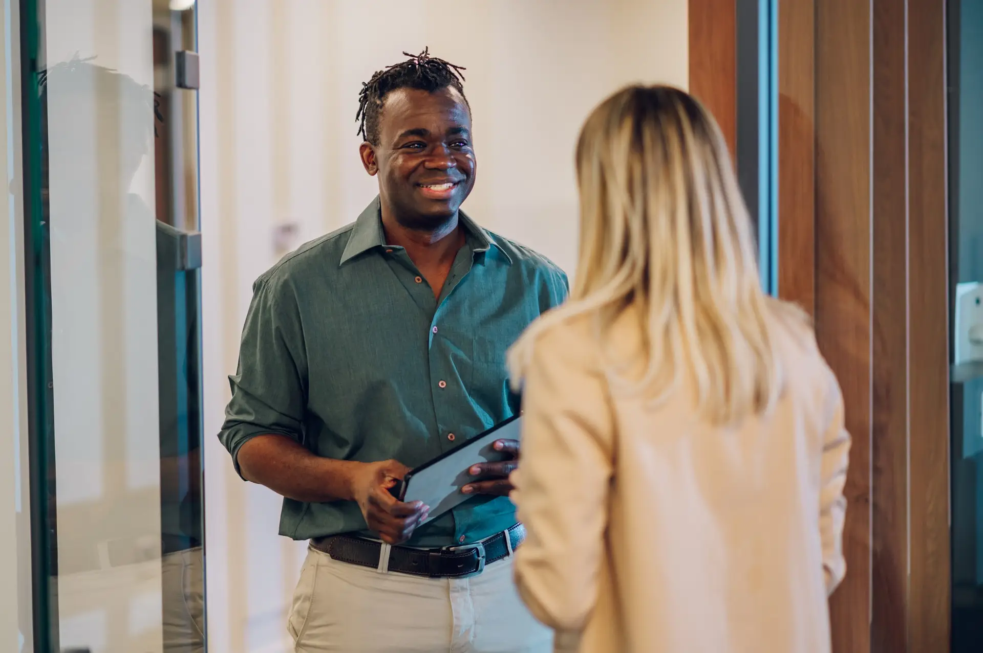 Two multiracial business colleagues working together on a digital tablet